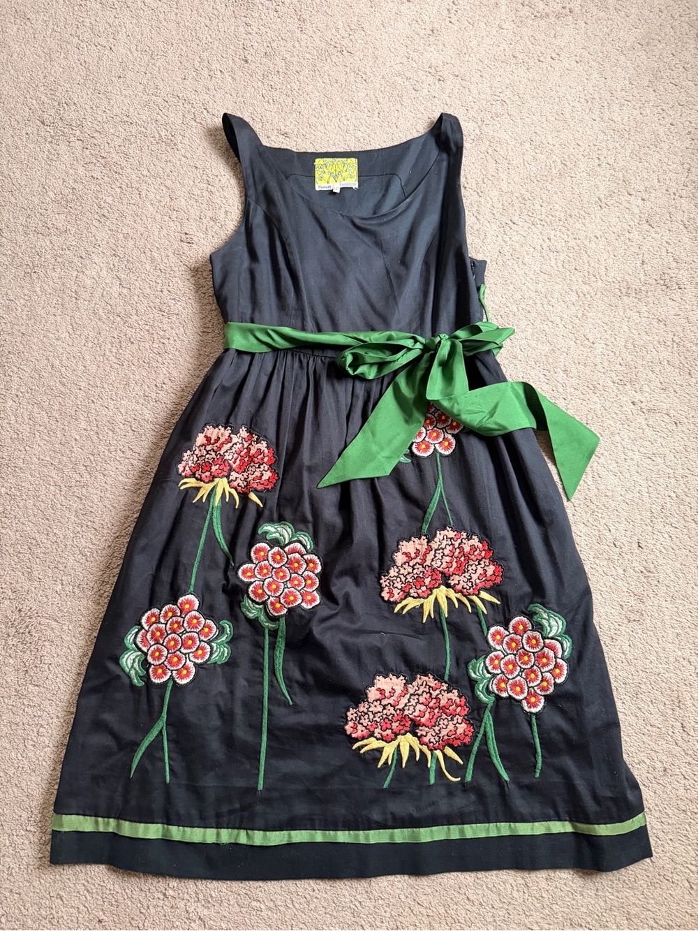 Floreat Black Garment with Yellow Floral Label